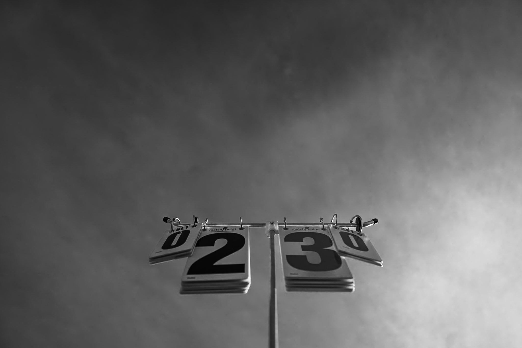 Scoreboard under stage lights, black and white